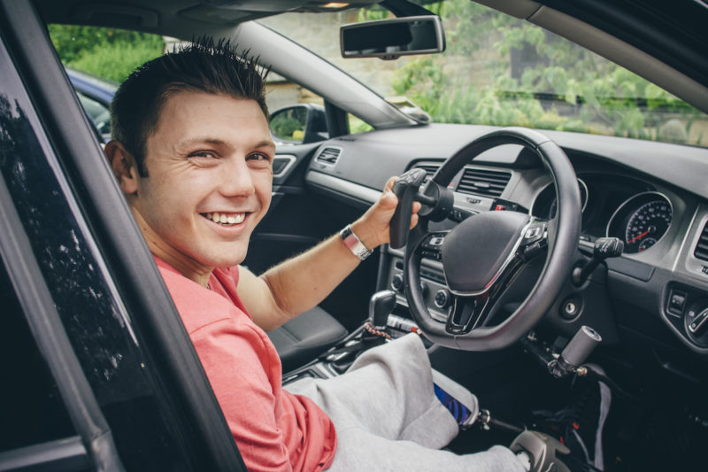 Man sitting a steering wheel of a car
